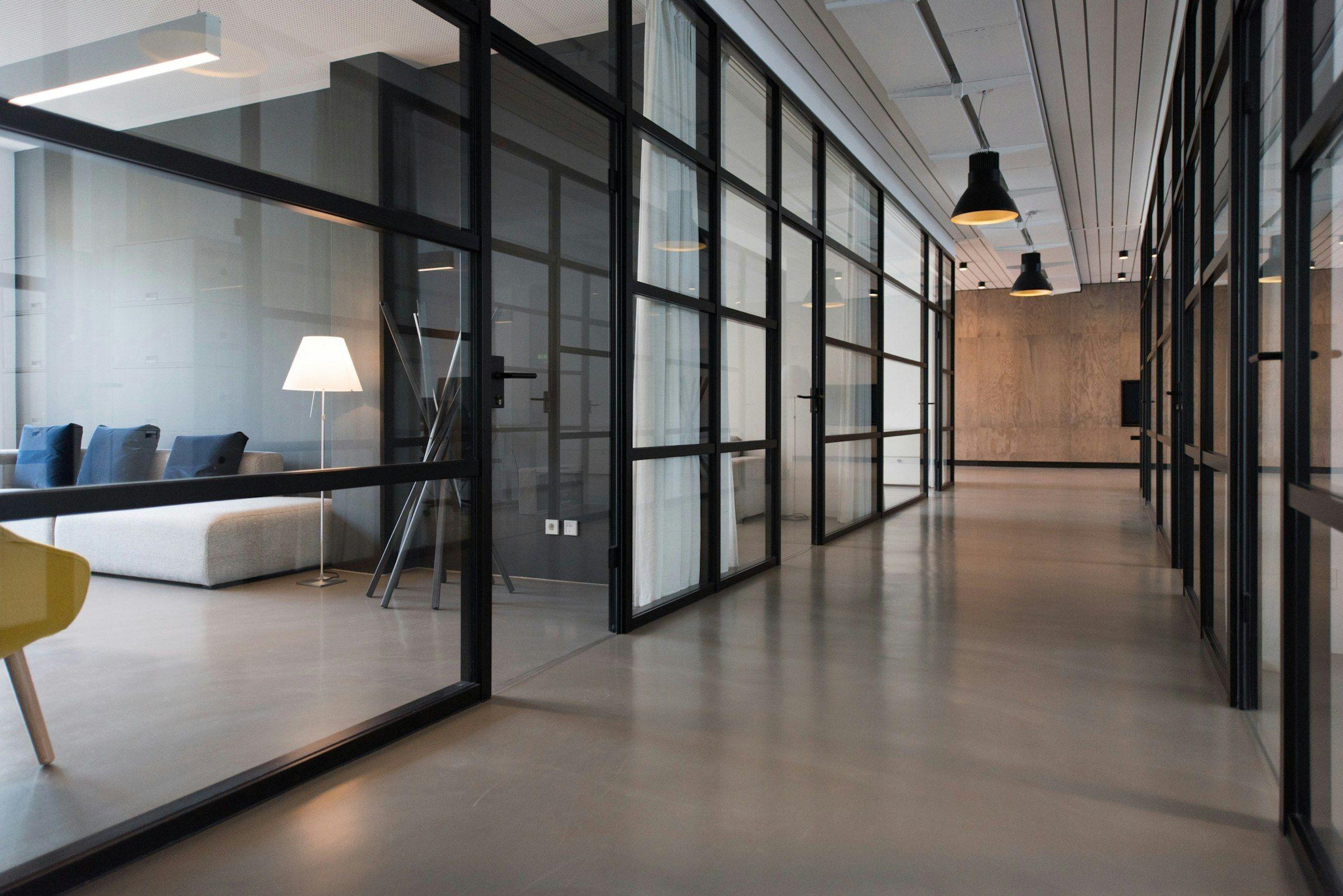 Glazed partition corridor in a converted industrial workspace